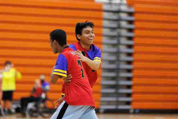 two boys playing soccer