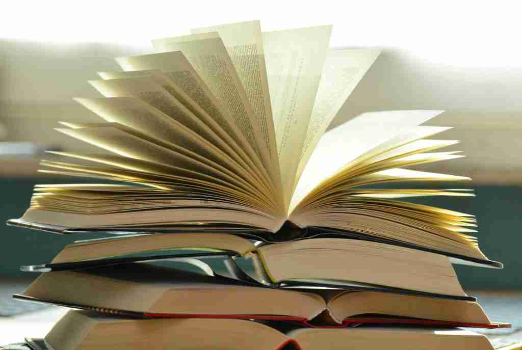 photo of a stack of open textbooks