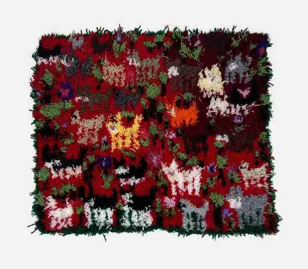 Colorful, textured rug featuring a vibrant mix of red, green, and other hues in an abstract floral pattern.